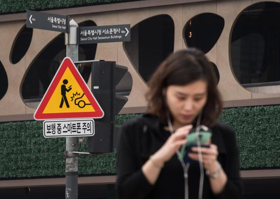 韩国推出手机低头族专用警示牌 避免发生交通事故