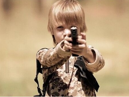 ISIS cold-blooded training! A blond boy executed a prisoner with a gun! .jpg