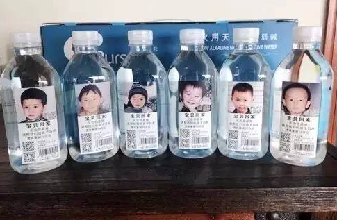 Positive energy transmission. Photos of missing children appear in mineral water bottles.jpg