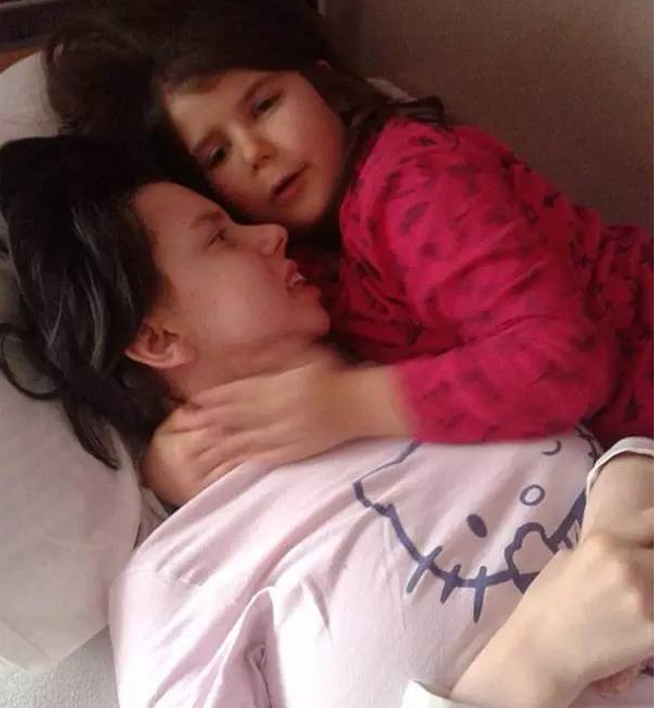 After 7 years of postpartum coma, a Serbian mother saw her daughter for the first time .jpg