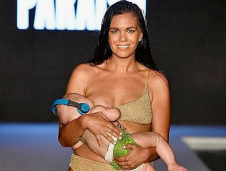 American female model breastfeeding her baby while walking on the show.jpg