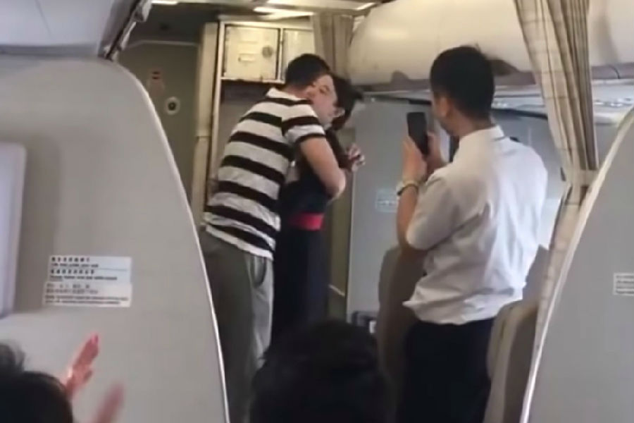 The flight attendant was fired after being proposed by her boyfriend on the plane and tearfully agreed .jpg