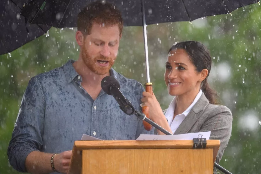 It’s raining and holding an umbrella to show affection. Prince Harry and his wife are too sweet. .jpg