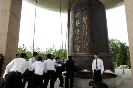 People bang the bell during a silent tribute to the people killed in the earthquake at the China Millennium Monument in Beijing, capital of China, May 19, 2008.