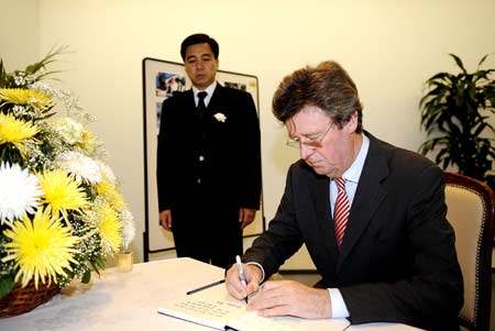 Steck, head of the Protocol Department of the German Foreign Ministry, leaves words on the condolence book to mourn China&apos;s earthquake victims, on behalf of German president, government as well as the Foreign Ministry, at the Chinese Embassy in Berlin, capital of Germany, May 20, 2008. 