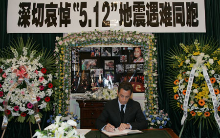 French President Nicolas Sarkozy leaves words on the condolence book as he attends the ceremony mounrning for victims in the earthquake happened in southwest China&apos;s Sichuan Province, in Chinese Embassy to France, Paris, France, May 19, 2008. 